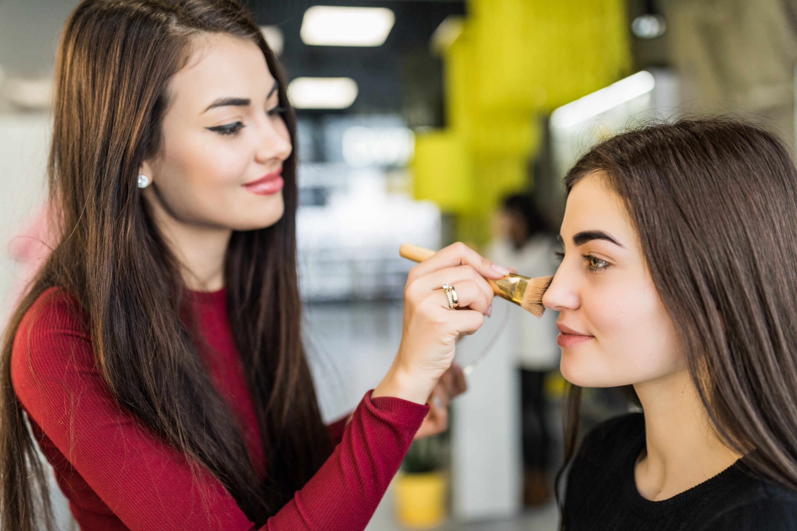 Pretty Master is making natural make-up to pretty model in salon
